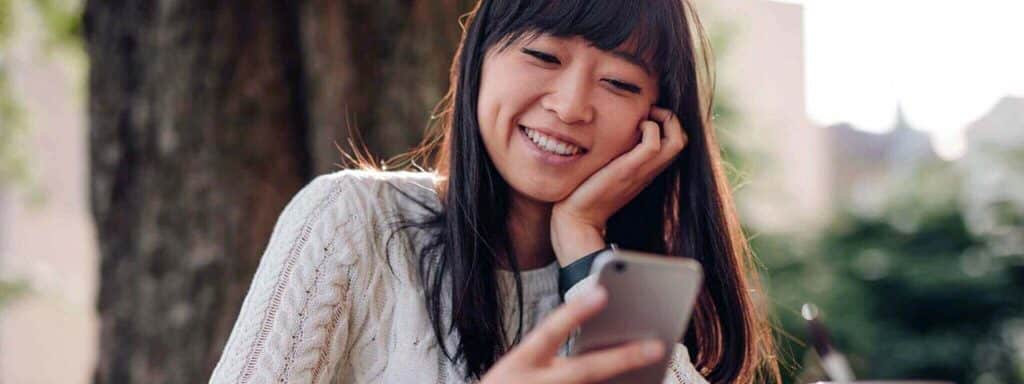 STUDIO FIVE - Increasing Website Engagement: A person using a smartphone outdoors.