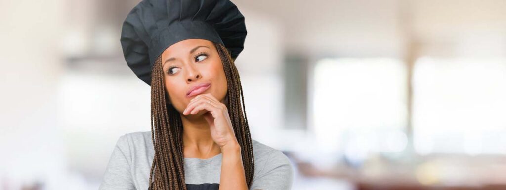 STUDIO FIVE - Deciding between Open-Source vs SaaS - Person in a chef hat thinking thoughtfully.