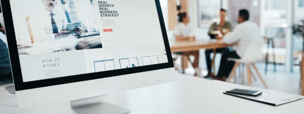 STUDIO FIVE - Comparing Open-Source vs SaaS Websites Control - Office setting with computer and people.