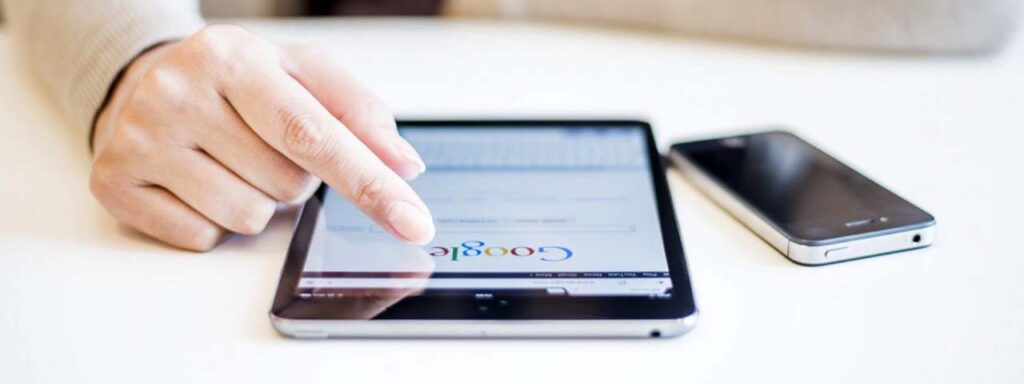 STUDIO FIVE - Comparing Open-Source vs SaaS Websites SEO - Person using tablet to search online