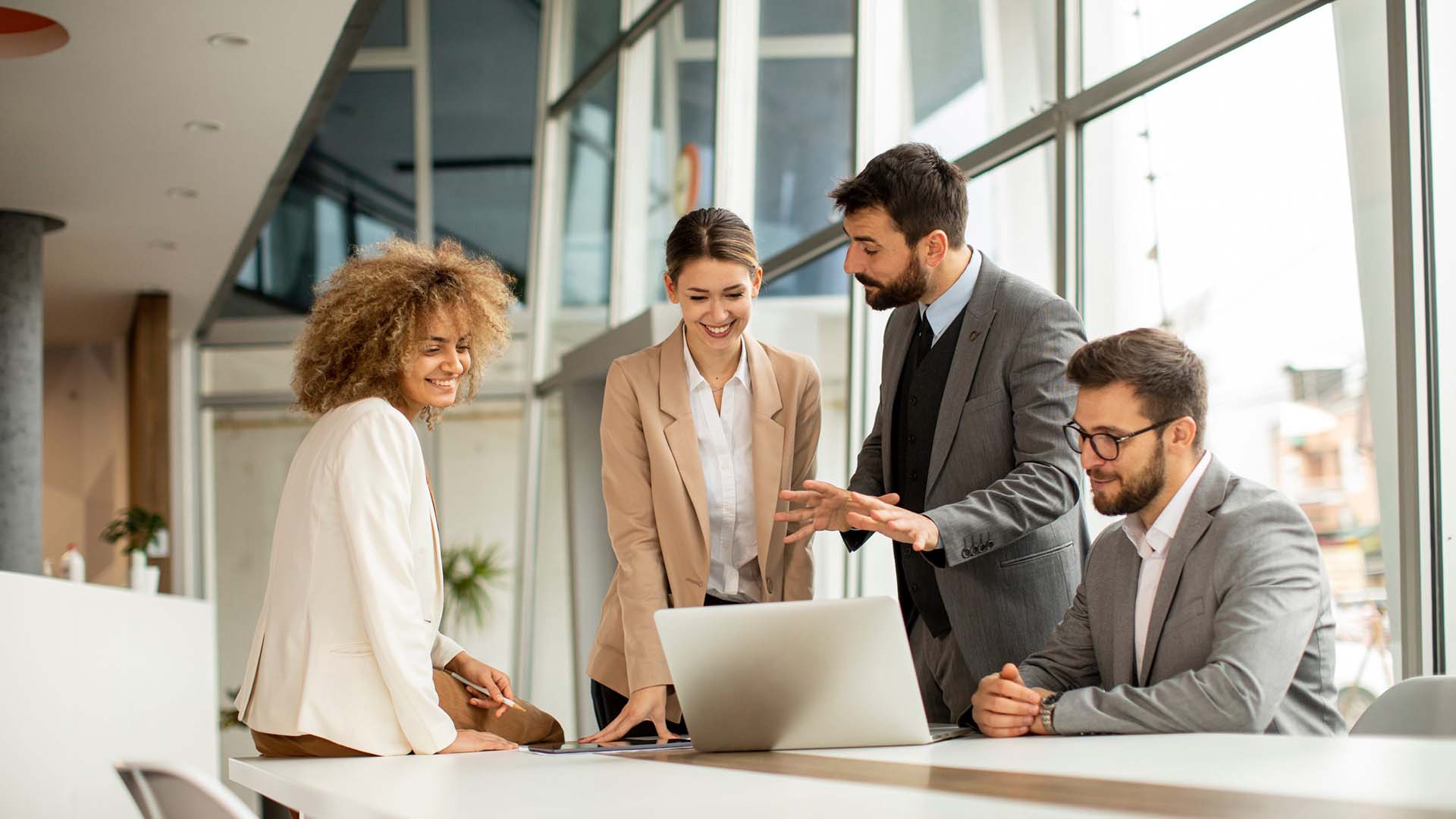 STUDIO FIVE - Comparing Open-Source vs SaaS Websites - Business meeting with laptop discussion.