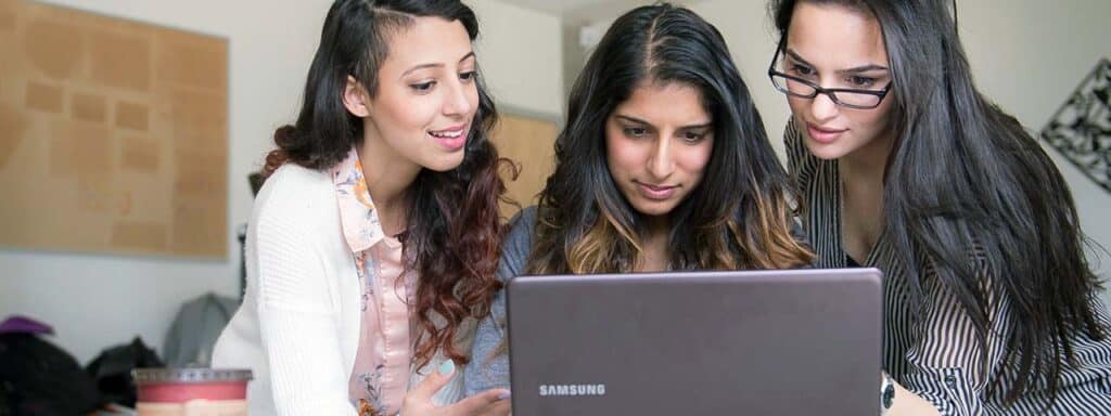 STUDIO FIVE - Increasing Website Engagement: Three people collaborating over a laptop.