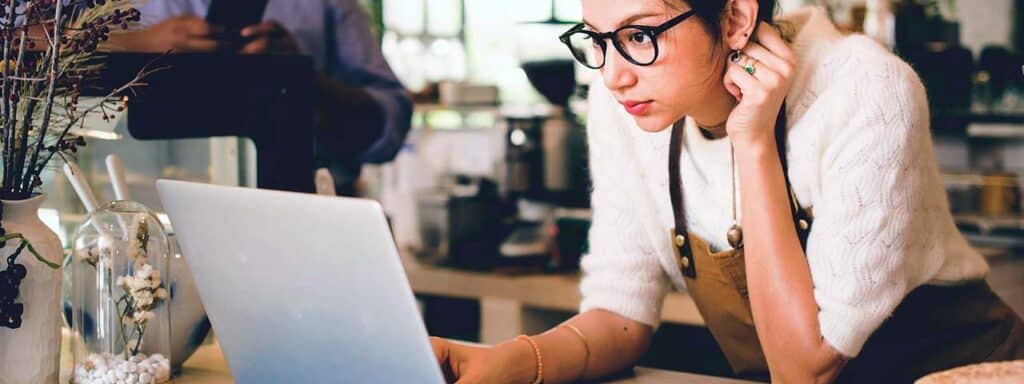 STUDIO FIVE - Increasing Website Engagement: A person working on a laptop in a café.