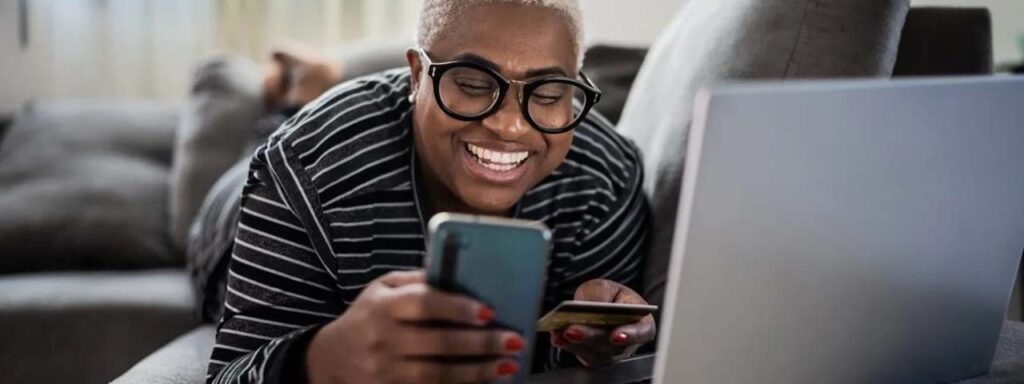 STUDIO FIVE: Person using phone and laptop.