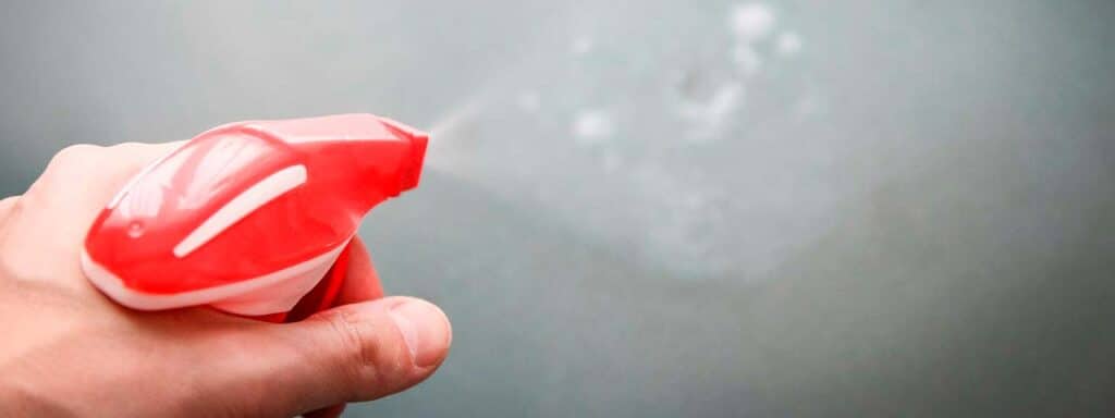 STUDIO FIVE - E-Commerce Spring Cleaning Tips: Hand holding red spray bottle
