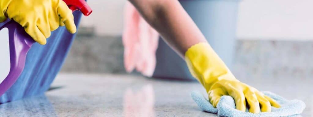 STUDIO FIVE - E-Commerce Spring Cleaning Tips: Person cleaning floor with gloves