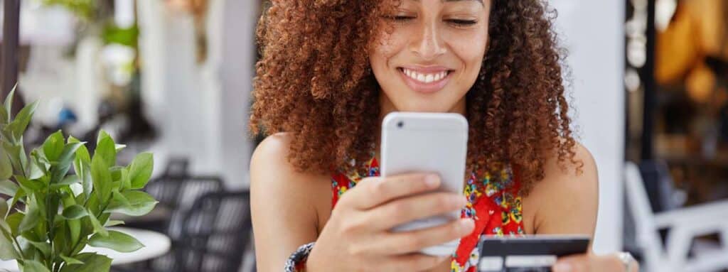 STUDIO FIVE - E-Commerce Spring Cleaning Tips: Person using phone and credit card.