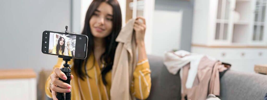 STUDIO FIVE - E-Commerce Spring Cleaning Tips: Person filming while holding clothing items.