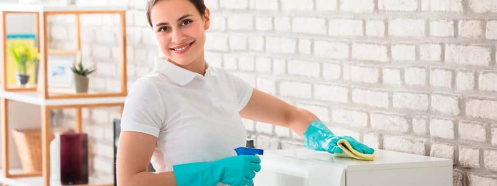 STUDIO FIVE - E-Commerce Spring Cleaning Tips: Person cleaning a surface with cloth.