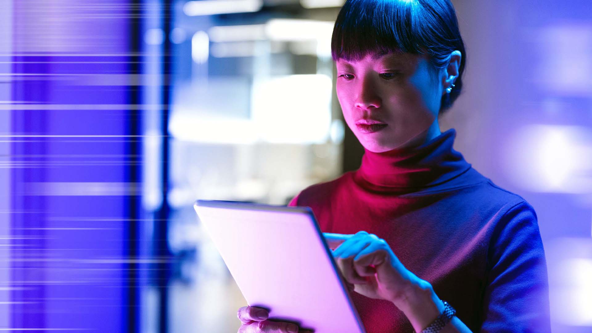 STUDIO FIVE - Agentic Web Design: Woman using tablet in vibrant lighting