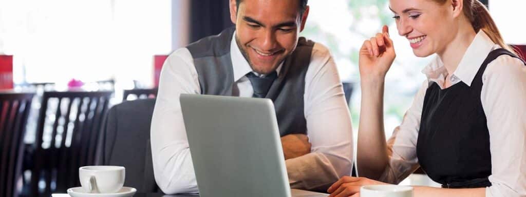 STUDIO FIVE - Benefits of Intelligent Web Systems: Two people discussing over a laptop.
