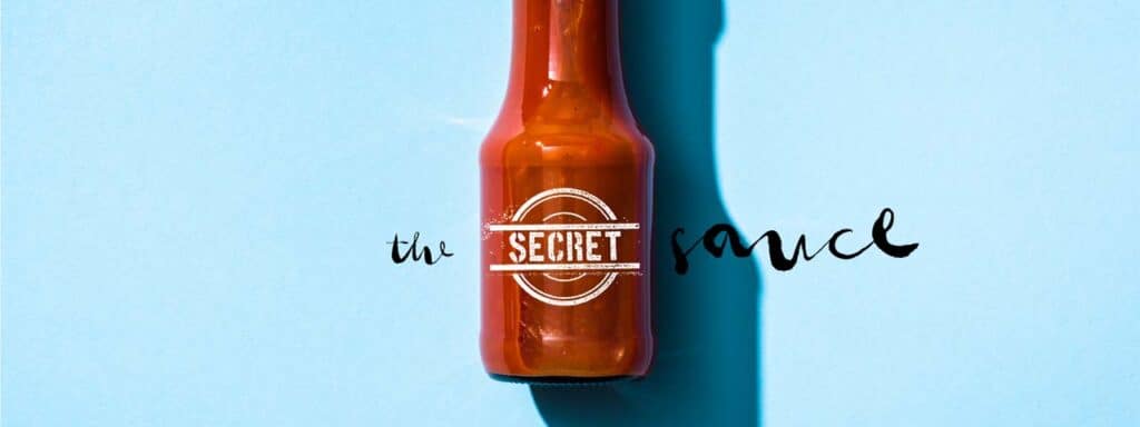 STUDIO FIVE - Intelligent Web Systems: Bottle of secret sauce on blue
