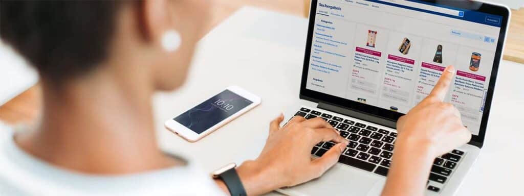 STUDIO FIVE - Reducing E-Commerce Shopping Cart Abandonment: Person browsing products on laptop