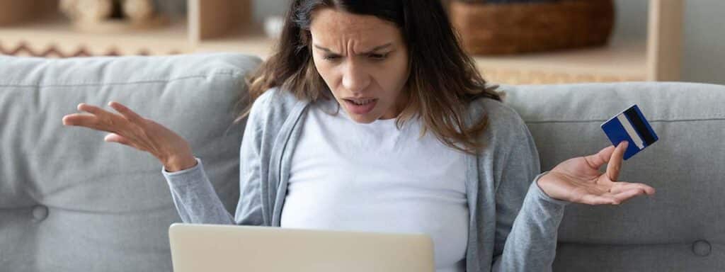 STUDIO FIVE - Reducing E-Commerce Shopping Cart Abandonment: Frustrated woman shopping online.