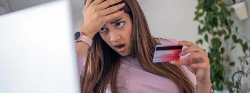 STUDIO FIVE - Reducing E-Commerce Shopping Cart Abandonment: Surprised woman holding credit card.